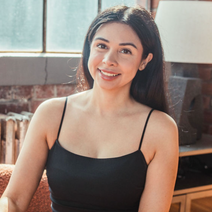 founder of Happy Cramps, smiling in a black tank top indoors